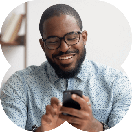 Boy smiling and using cellphone